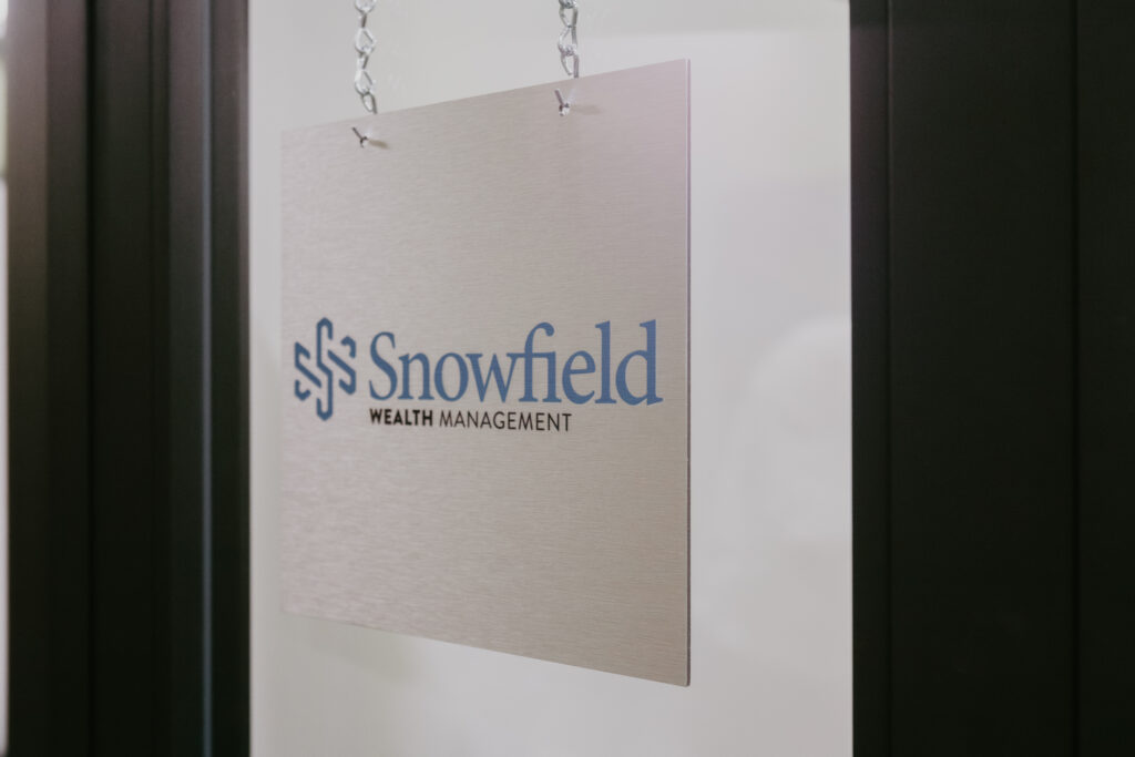 Snowfield Wealth Management office sign hanging at the Midland, Michigan location