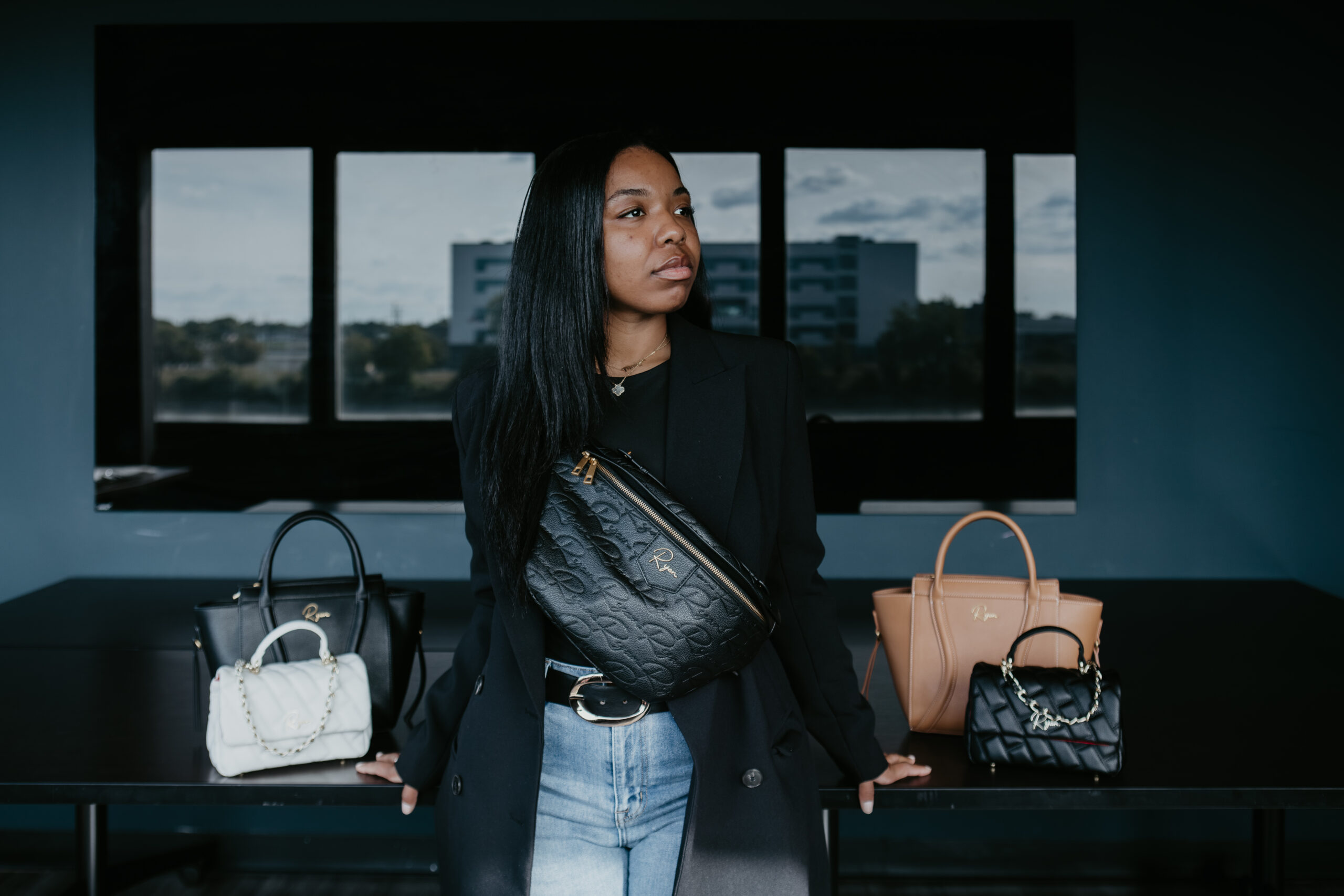 Ja’Maiya Ryan with Ryan Studio & Company handbags during branding photography session in Saginaw Michigan.