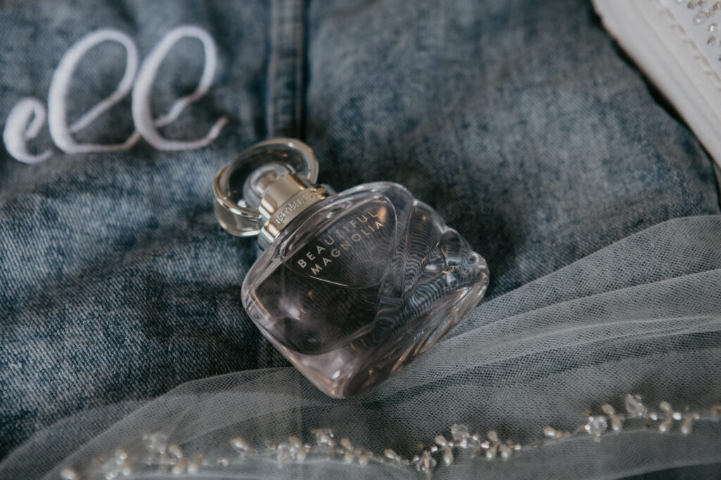 Beautiful Magnolia perfume bottle styled with bridal accessories before wedding at Fenton Winery & Brewery in Michigan captured by Arielle Roth Photography